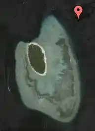Satellite dive map pinpointing the location of the Coral Gardens dive site on the shallow reef top of Sipadan Island.