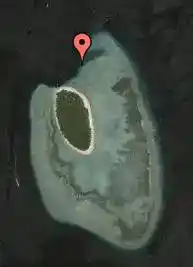 Satellite dive map pinpointing the entrance to Turtle Cavern, the legendary underwater cave system at Sipadan Island.