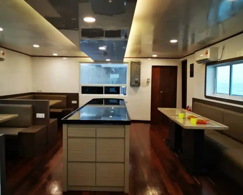 Modern and spacious lounge and dining area aboard the MV Celebes Explorer 9, where divers can relax and dine while cruising to Sipadan.