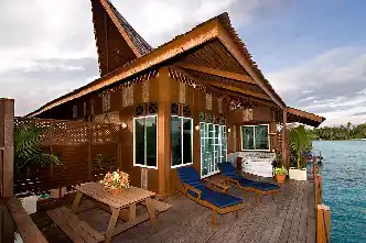 Private outdoor jacuzzi on the balcony of a Borneo Villa at Mabul Water Bungalows, offering ultimate relaxation with a stunning ocean view.