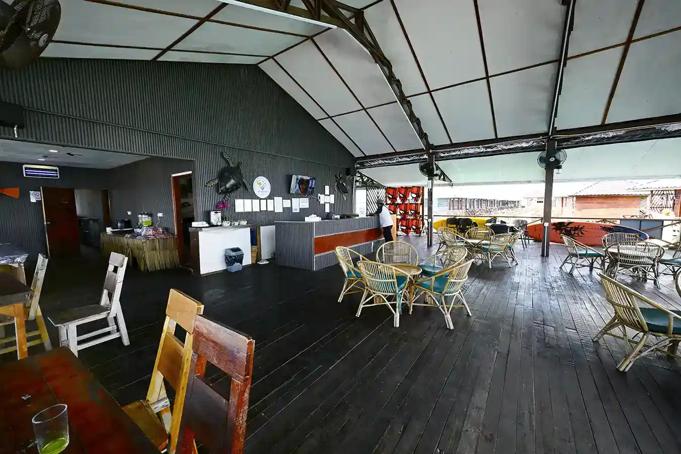 Spacious open-air restaurant and reception area at Sky Water Villas, with casual seating and views of the surrounding sea.