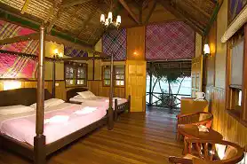 Your charming island retreat with stunning sea views. Spacious and charming island room at Lankayan Resort, featuring four-poster beds and a private balcony with beautiful ocean views.