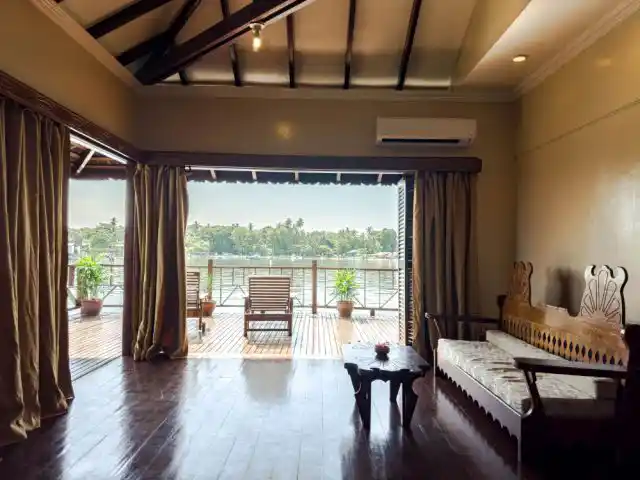 Unwind on your sea-view deck between adventures. Spacious Deluxe Cottage interior at Sipadan Water Village flows onto a sea-view deck where divers and snorkelers unwind between adventures.
