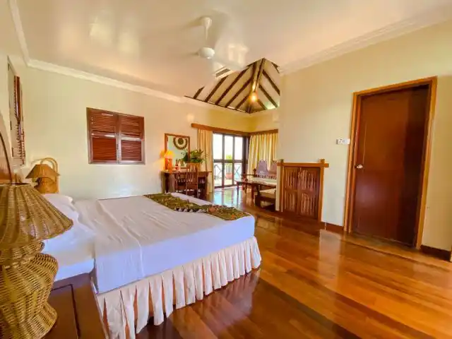 Enjoy the beauty and comfort of our deluxe cottage. Beautifully appointed Deluxe Cottage at Sipadan Water Village, with gleaming hardwood floors, a high ceiling, and a private balcony overlooking the sea.
