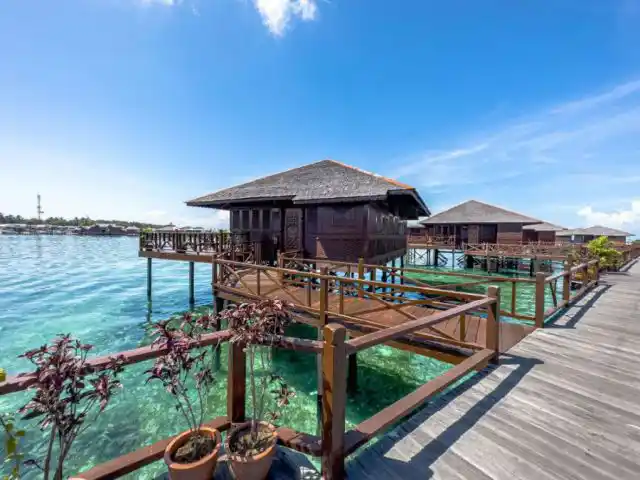 Easy access to the reef from your overwater chalet. Row of Grand Deluxe over-water chalets at Sipadan Water Village gives snorkelers and divers easy boardwalk access to Sabah's lively reefs.
